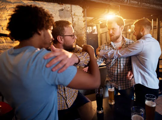 Drunk men at a bar getting arrested, needing a DUI attorney