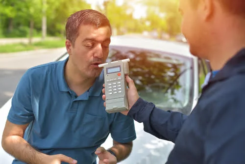 Rhode Island state police giving breathalyzer to man in car