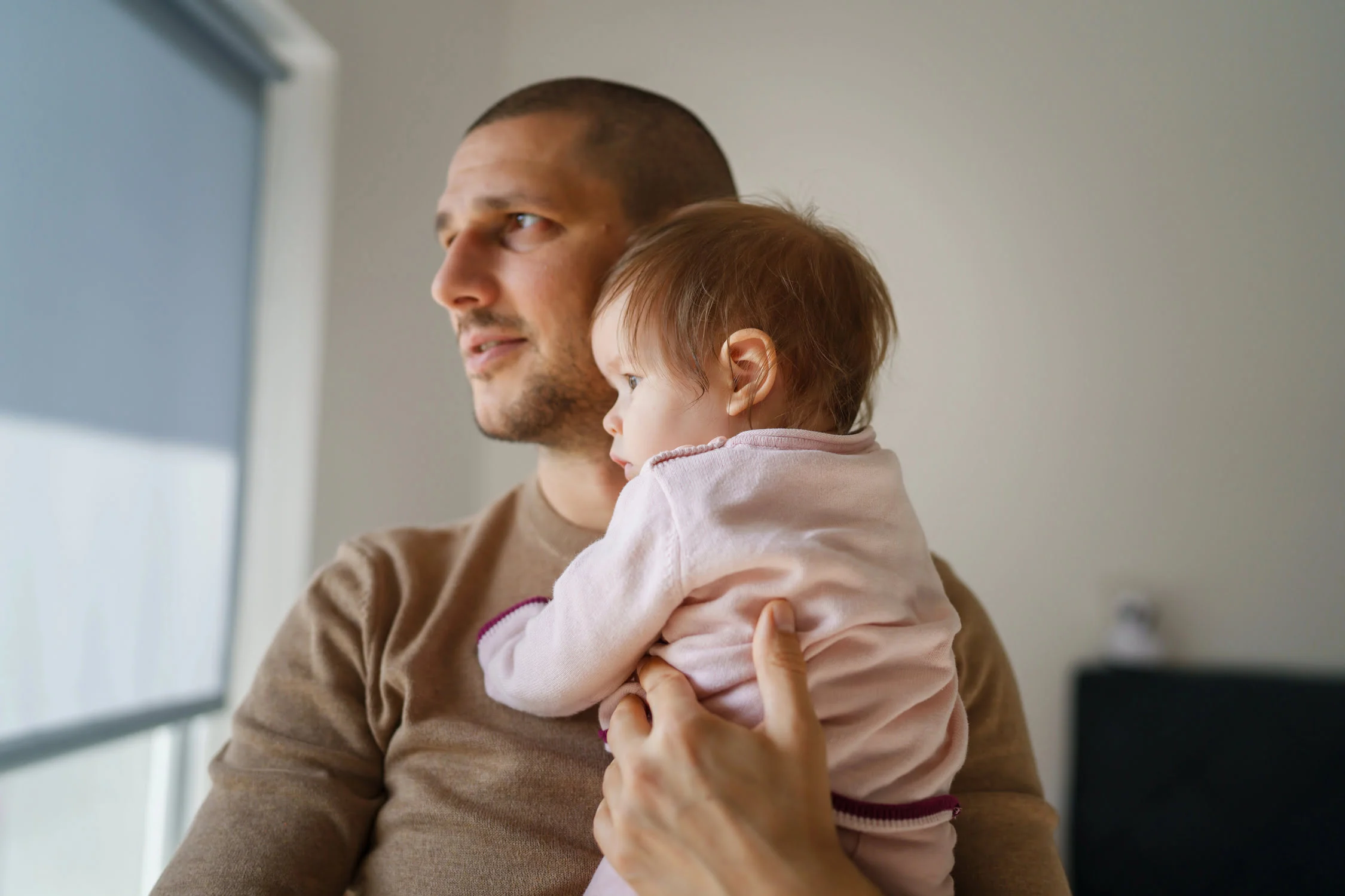 Father kissing his baby as he adds children to his will