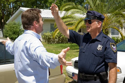 Rhode Island police office giving field sobriety test to RI drunk driver